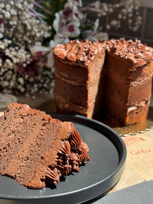 Margaret’s Signature Dark Chocolate Cremeux Cake (She never smiled while baking it — but we did while eating it.)